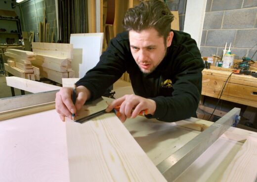 Luke measuring a bench top rail for modification