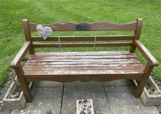 Front view of a 30 year old Beverley Bench with tan varnish