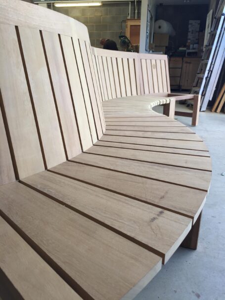 Curved bench positioned by the fire pit