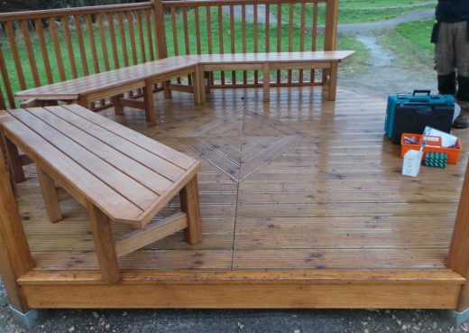 Installing the seating inside the wooden play shelter