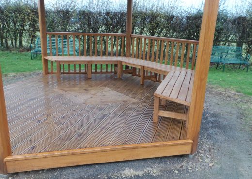 Wooden seating inside the wooden play shelter