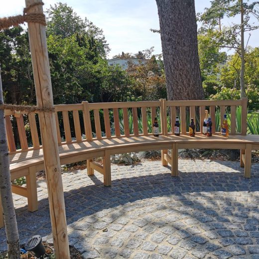 Curved bench with side table ends