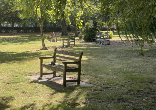 Old Woodcraft memorial benches positioned throughout the peaceful tree-lined grounds at Chanterlands Crematorium in Hull.