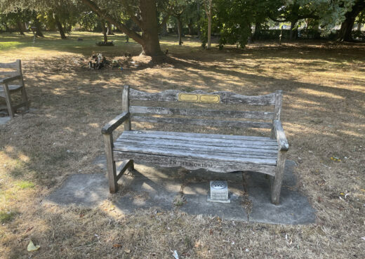 Naturally weathered Woodcraft Beverley memorial bench with dedication plaques at Chanterlands Crematorium.