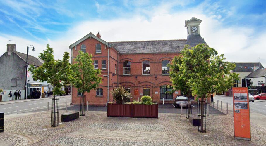 Timber planters in Dromore town square in front of red brick town hall building