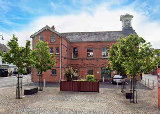 Timber planters in Dromore town square in front of red brick town hall building