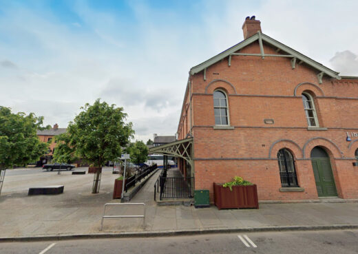 Timber planter installed along roadside in Dromore with surrounding buildings