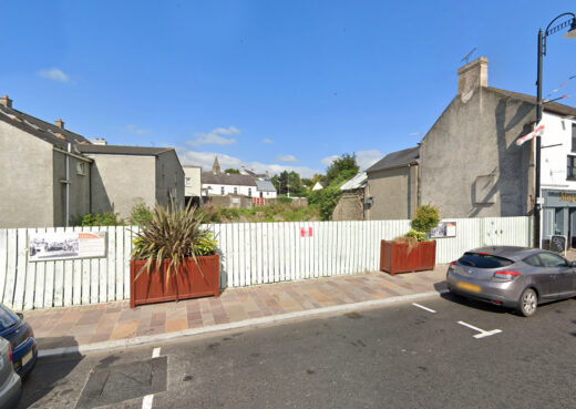 Close view of timber planter beside Dromore Town Hall on paved street