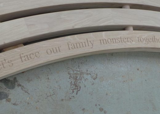 Bench engraved with the words: let's face our family monsters together