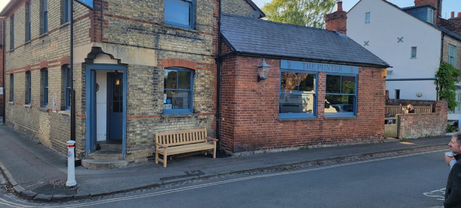 Wide view of The Punter pub with the Johnny Morrison memorial bench positioned beside the entrance.