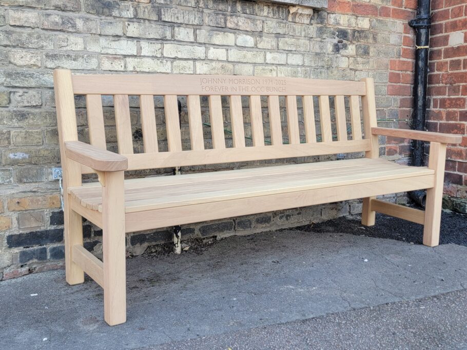 Handcrafted iroko York memorial bench with engraved dedication to Johnny Morrison outside The Punter.