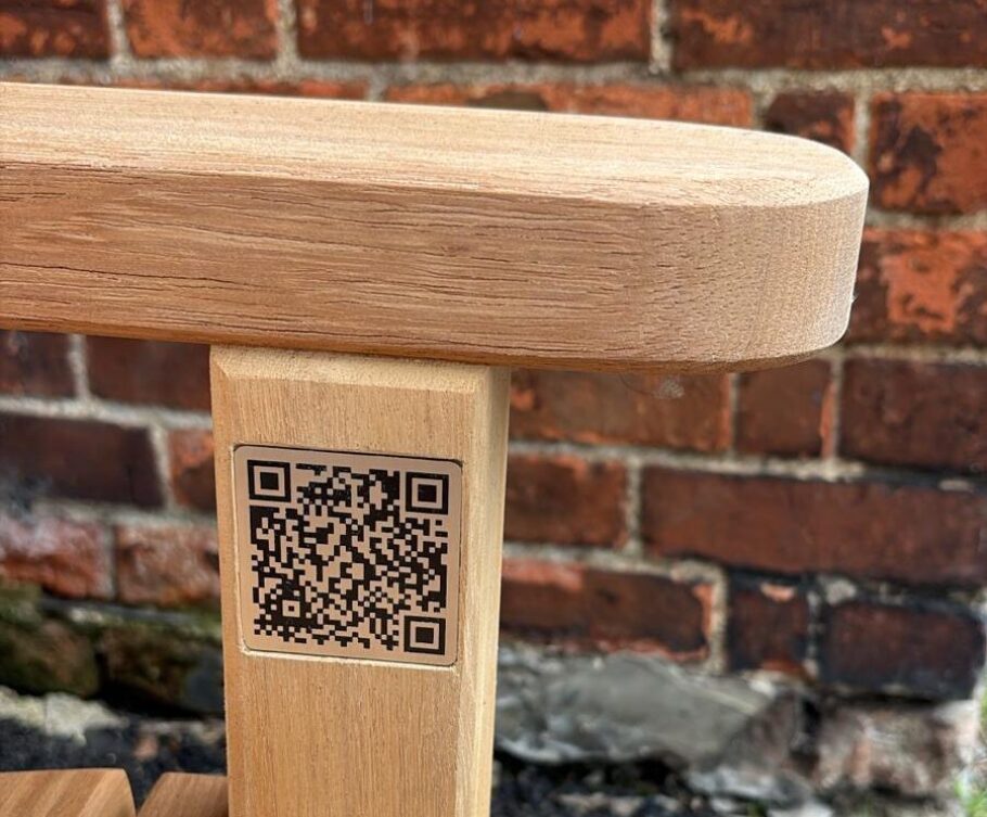 QR code mounted on the side of the Johnny Morrison memorial bench linking visitors to the memorial page about Johnny's life and connection to Oxford Cycling Club.