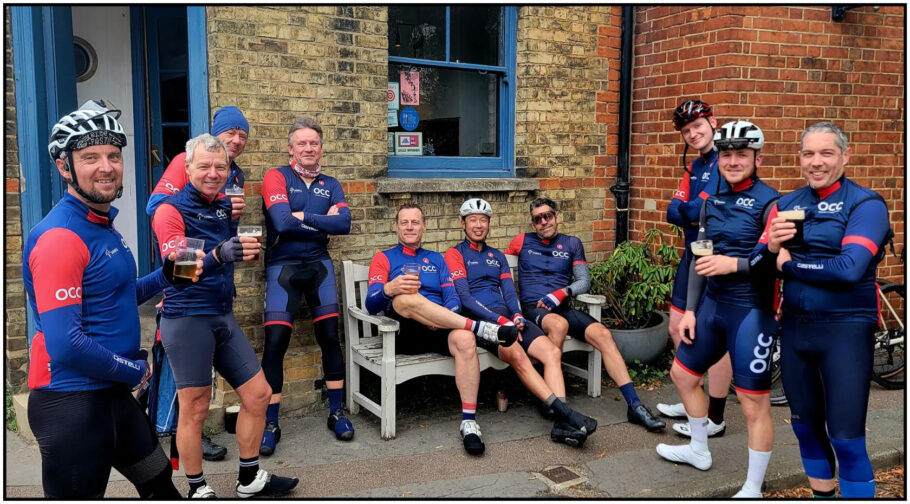 Members of the Oxford Cycling Club with Johnny Morrison sat on and around the previous old bench outside the Punter Bar.