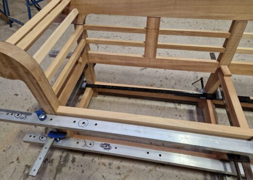 Close up of the Low Back Lutyens Bench in Construction being clamped during the bonding process.