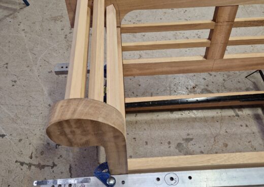 The classic scrolled armrest of the Low Back Lutyens Bench in Construction.