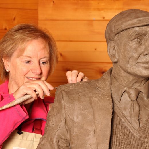 Jill Atley working on a Yorkshireman on a bench sculpture