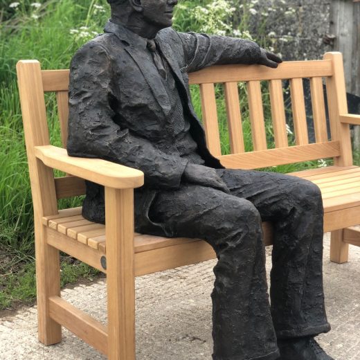 Side view of Arthur the bronze sculpture on our garden bench