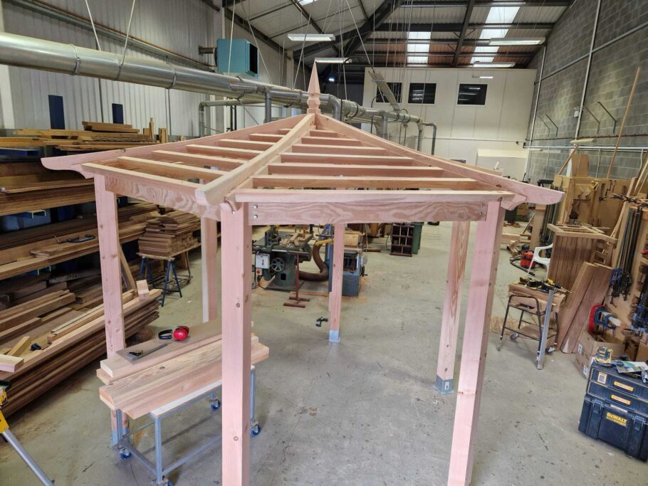 Full-height view of the bespoke pergola structure assembled in the Woodcraft workshop