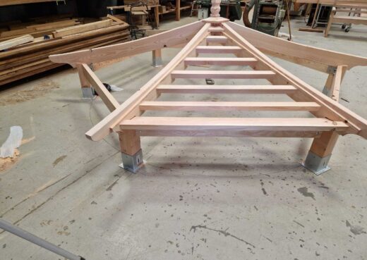 Roof framework of a bespoke wooden pergola being assembled in the Woodcraft workshop