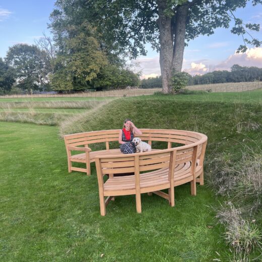 The new Rosedale Curved bench shown off in a garden