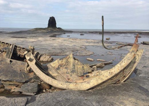 Shipwreck at Saltwick Bay with Black Nab in the distance