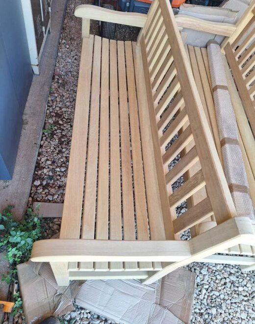Handcrafted York wooden bench at Souda Bay War Cemetery in Crete shortly after delivery, showing slatted seat and solid armrests