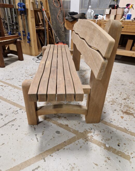 Curved hardwood Waveform bench with sculpted slatted seat