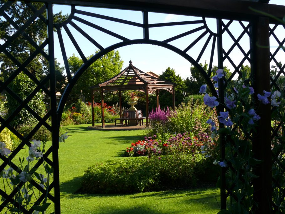 Wooden Gazebo framed by a Garden Pergola