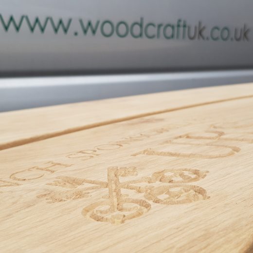 Logo inscription carved into the wooden bench