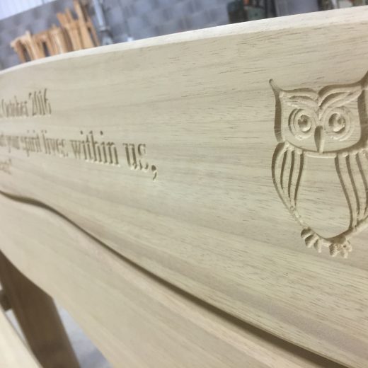 Engraved wooden bench with owl motif