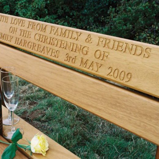 Engraved top rail of garden bench