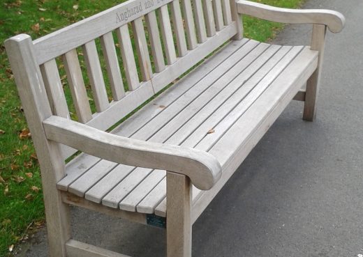 A weathered York bench in use by the Chelsea Pensioners