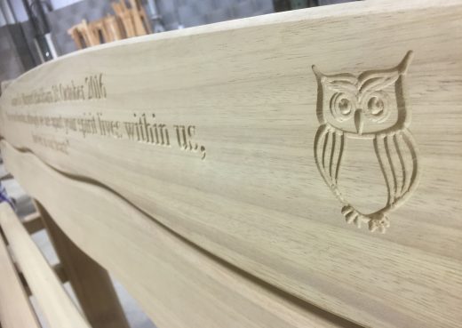 Engraved wooden bench with owl motif