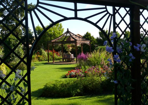 Wooden Gazebo framed by a Garden Pergola