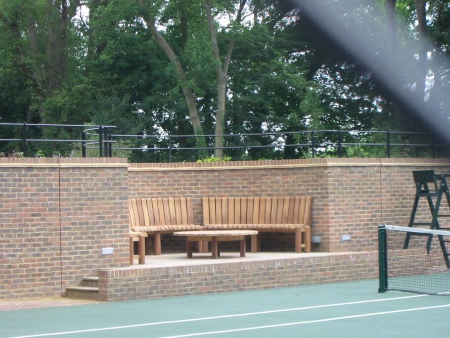 Table and curved chair set in a tennis court