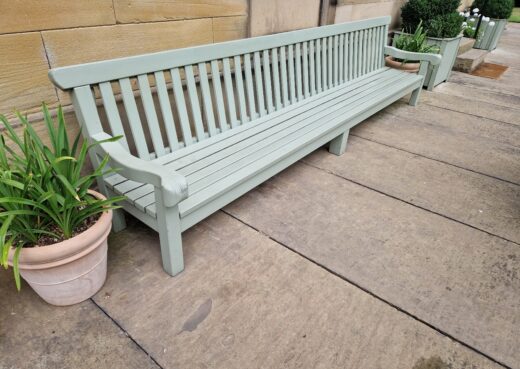 Side view of the Saltmarshe Bench with scrolled arm rests