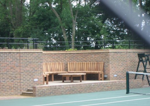 Table and curved chair set in a tennis court