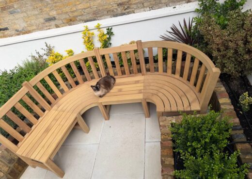 Bespoke curved garden seating designed to follow the shape of a landscaped garden