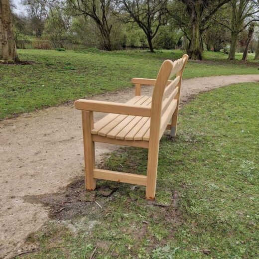 Memorial bench set into ground beside path in East Park Hull