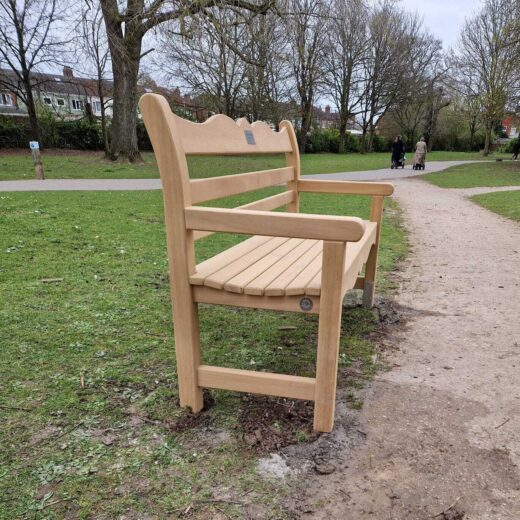 Side view of handcrafted wooden bench during installation in East Park