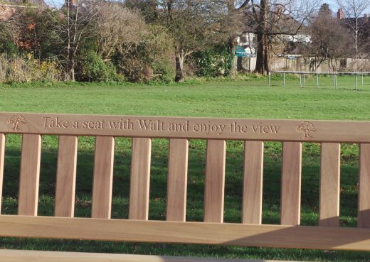 Wooden bench memorial inscription: Take a seat with Walt and enjoy the view