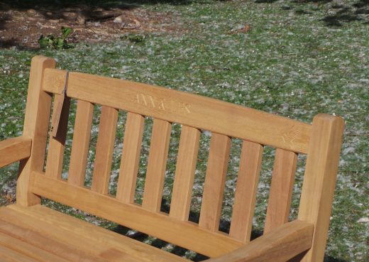 Close up of the engraving on the top rail on the East Park bench