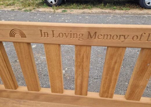 Close-up of the engraved inscription reading "In Loving Memory of David Patrick Sullivan"