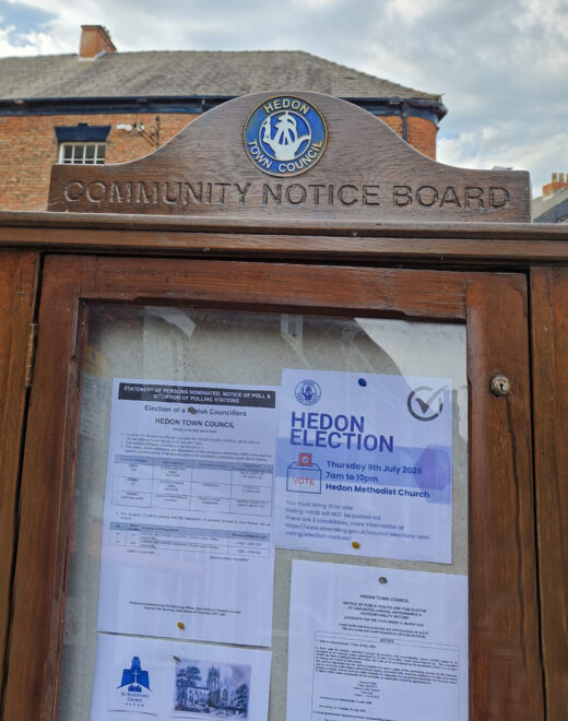 Close-up of the handcrafted timber notice board featuring the Hedon Town Council crest.