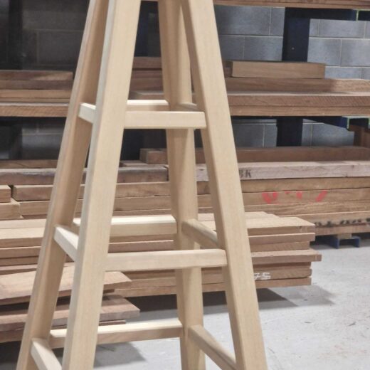 Mid-section close-up of a completed wooden obelisk showing evenly spaced rungs and clean joinery.