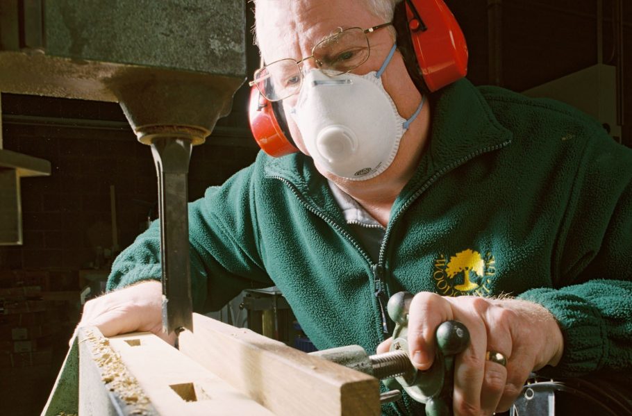 Using a dust mask while operating woodworking machinery