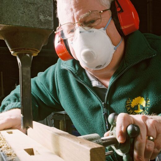 Using a dust mask while operating woodworking machinery