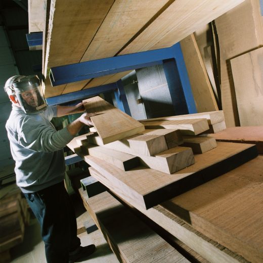 Woodcraft UK's craftsman selecting timber ready for construction of a large wooden bench