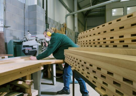 Mike Davidson operating woodworking machinery