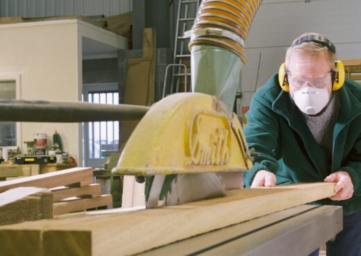 Mike Davidson cutting timber lengths for a large wooden bench